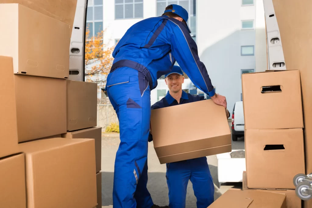 Two men are move a house items 