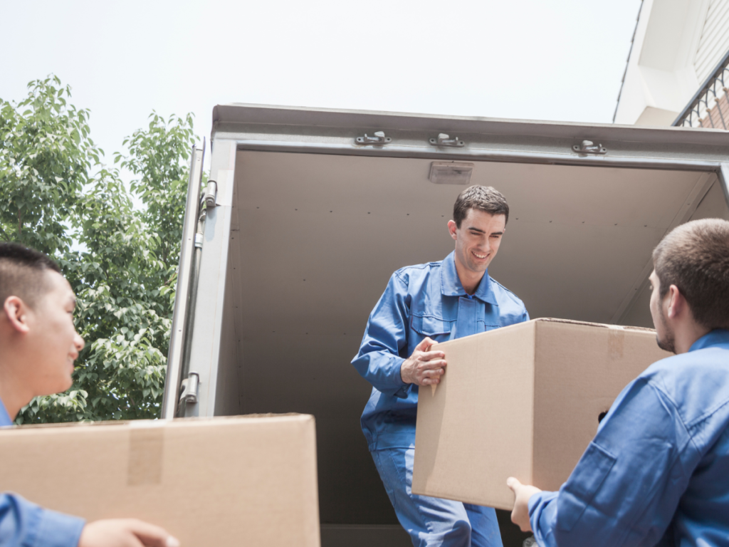 Three men's are helping each other to move a boxes in new jersey