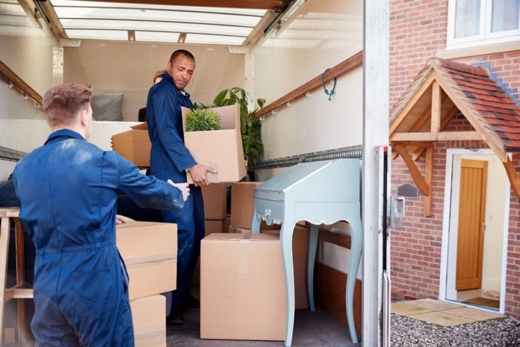 Two mens help each other to moving boxes in truck and moves in new jersey